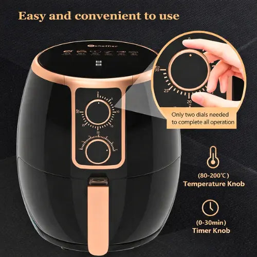 Black and rose gold air fryer with temperature and timer knobs on a dark background