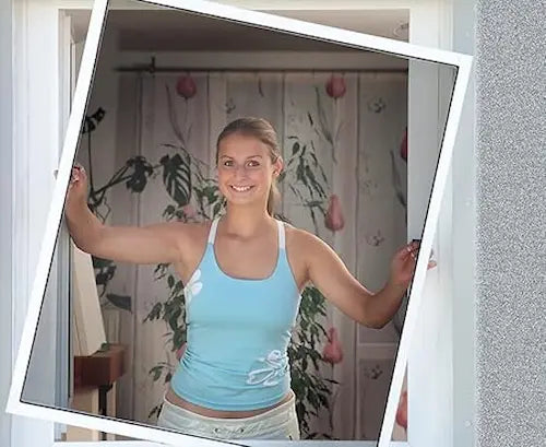 Woman in a blue tank top standing in front of a floral curtain