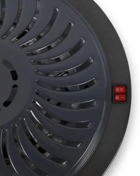 Black circular device with a red power switch on a white background