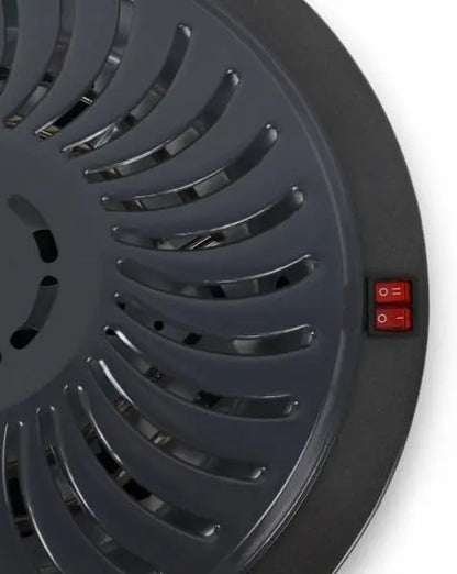 Black circular device with a red power switch on a white background