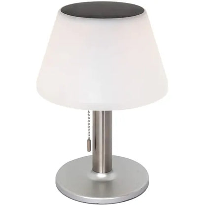 Table lamp with white shade, black top, and silver base on a white background
