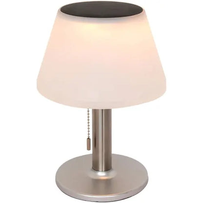 Table lamp with white shade and metallic base on a white background