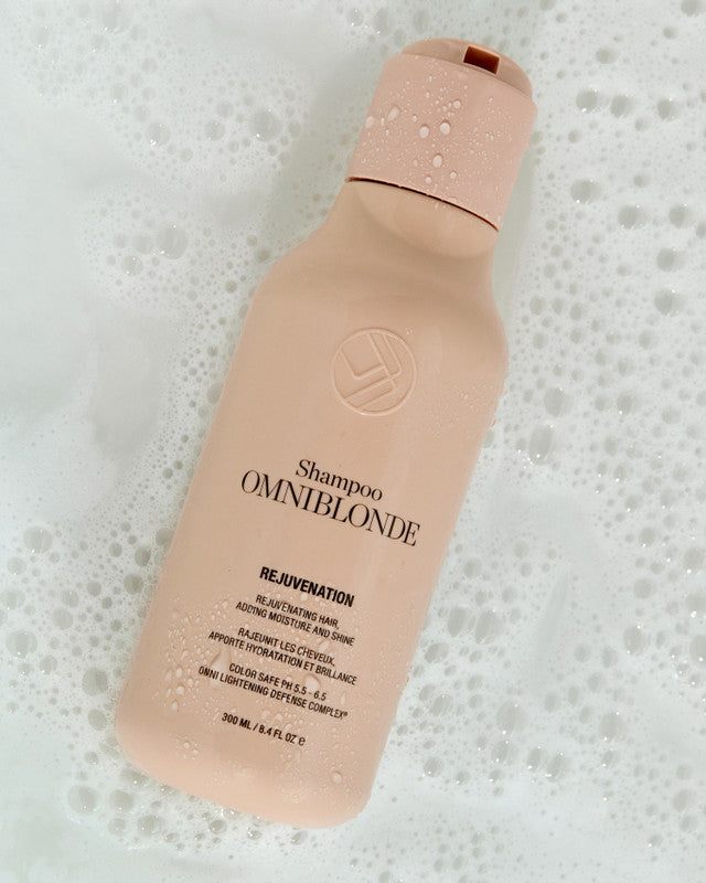 Omniblonde shampoo bottle on a textured white background