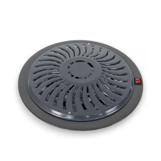 Round black heater with red button on a white background