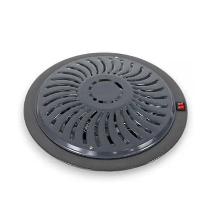 Round black heater with red button on a white background