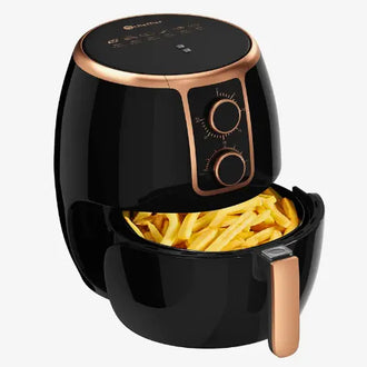 Black and rose gold air fryer with French fries inside on a white background