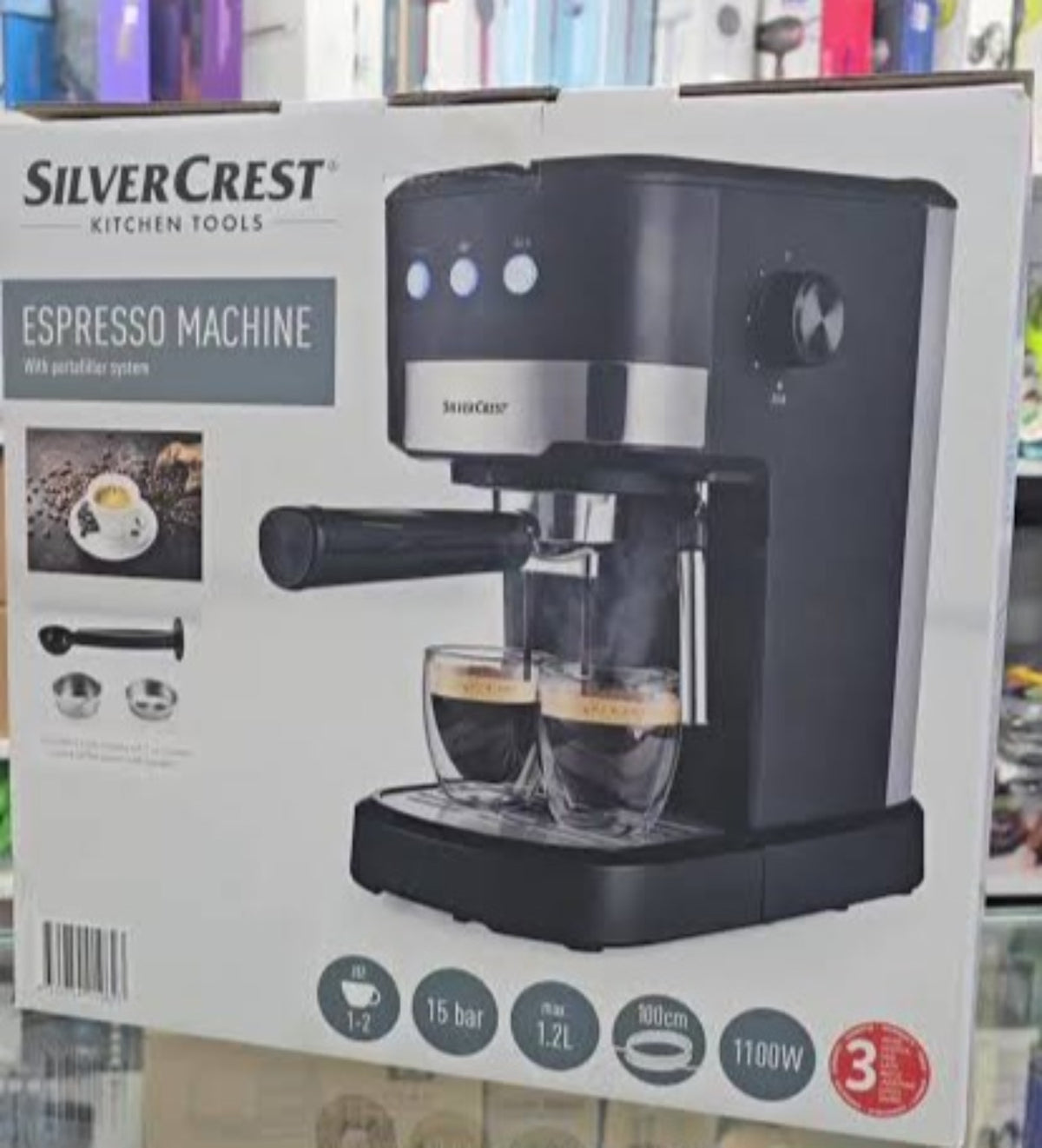 SilverCrest espresso machine with portafilter, 15 bar pressure, 1.2 L tank and 1100 W power, shown on its original packaging