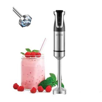 Hand blender next to a glass of pink smoothie with raspberries and mint leaves on a white background
